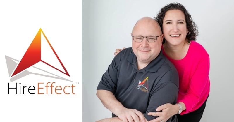 Two smiling HireEffect team members pose together beside the company’s logo, featuring a red and orange geometric design.
