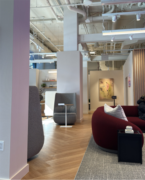 Interior of TurboTax store with gray and burgundy chairs in modern environment.