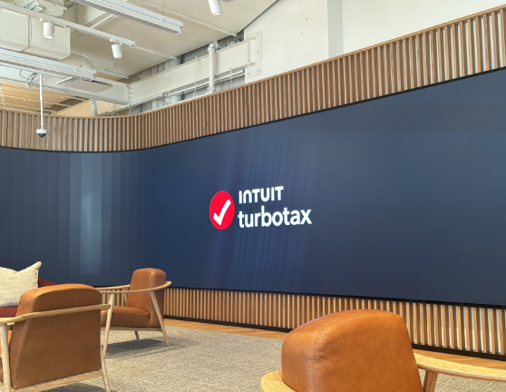 Interior of TurboTax store with blue wall and logo.