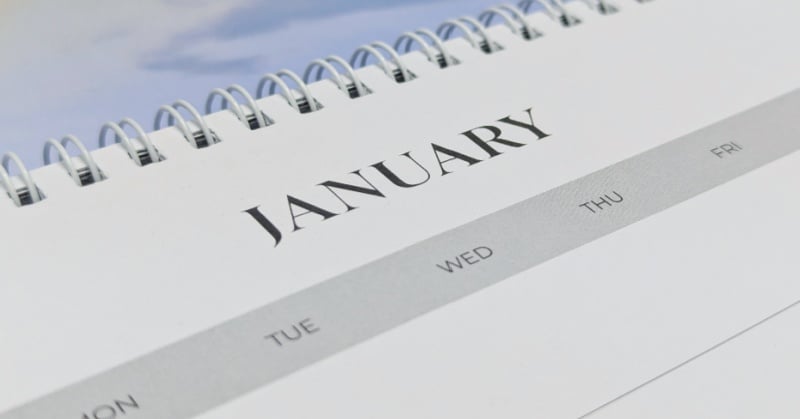 Close-up of a spiral-bound calendar turned to January, symbolizing the start of the year and key deadlines for accountants and tax professionals.