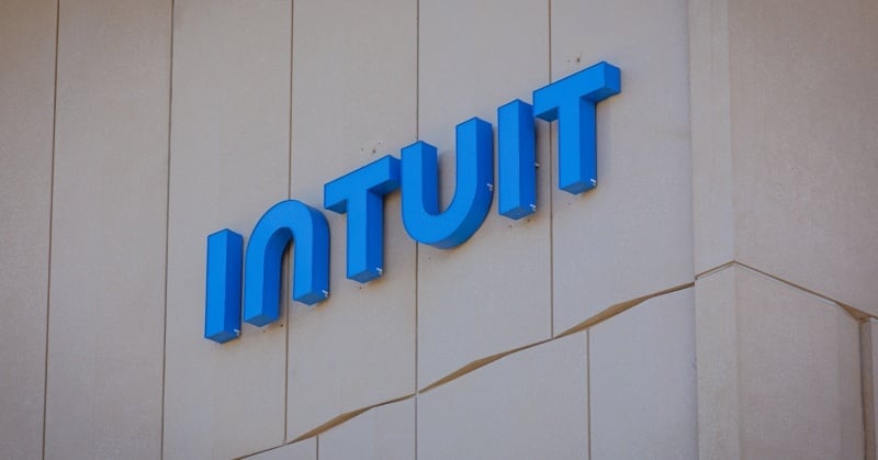 Blue Intuit logo mounted on the exterior wall of a beige office building.