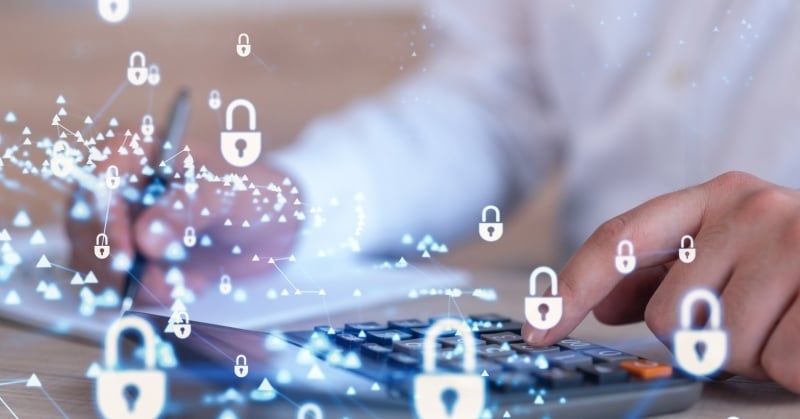 Person using a calculator with digital padlock icons overlaid, symbolizing cybersecurity in accounting and data protection for CPA firms.