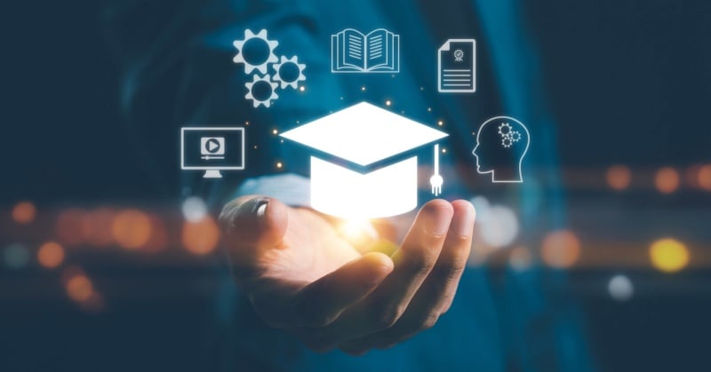 A person holding a glowing graduation cap icon surrounded by floating educational and technology-related icons, representing digital learning and training.