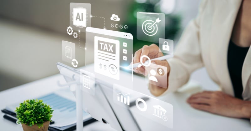 Accounting professional using a tablet with digital tax compliance and AI icons displayed.