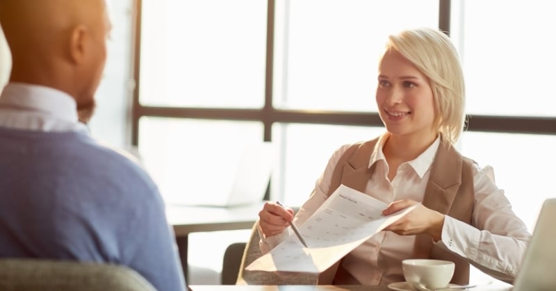 Accounting advisor reviewing a financial document with a client during a professional consultation.