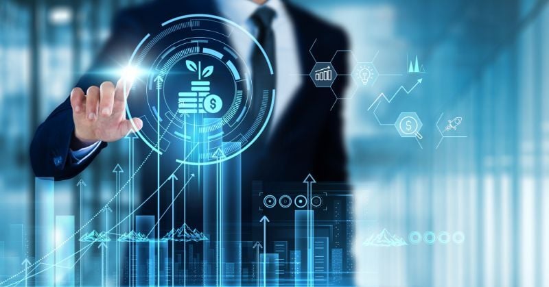 Business professional interacting with a digital financial growth dashboard featuring investment, revenue, analytics, and technology icons.