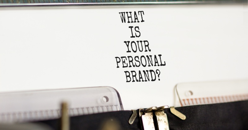 A vintage typewriter types the phrase "WHAT IS YOUR PERSONAL BRAND?" on white paper in bold, black, uppercase letters.