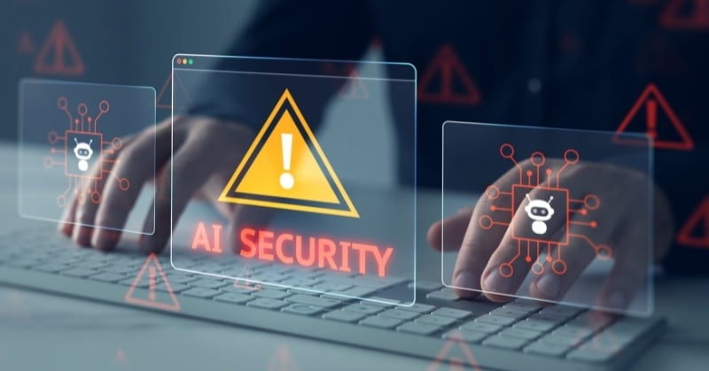AI security warning icons and chatbot symbols displayed over a person typing on a laptop.