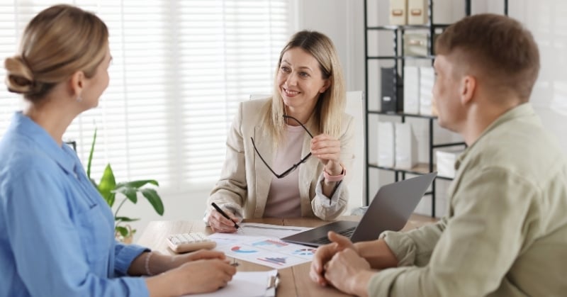 Accountant meeting with clients to discuss tax documents and improve the tax preparation process ahead of the filing deadline.