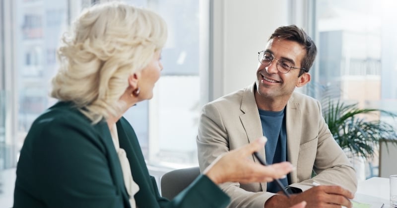 Client speaking with an accounting professional during a collaborative meeting in a bright office.