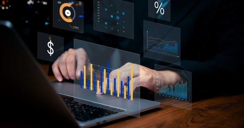 Business professional analyzing digital financial dashboards on a laptop, representing accounting automation and data-driven client advisory services.