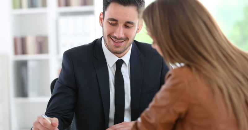Accountant advising a client during a meeting in an office setting, highlighting proactive financial planning and advisory services.
