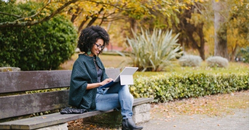 Young accountant working on her computer on a beautiful fall day.