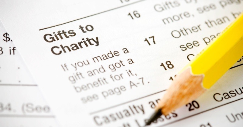 pencil pointing to tax form words "Gifts to Charity" visible on sheet