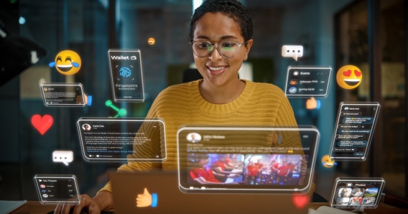 Short haired project manager in yellow sweater with glasses using employee productivity and time tracking software on computer in office with colorful holograms in front of her