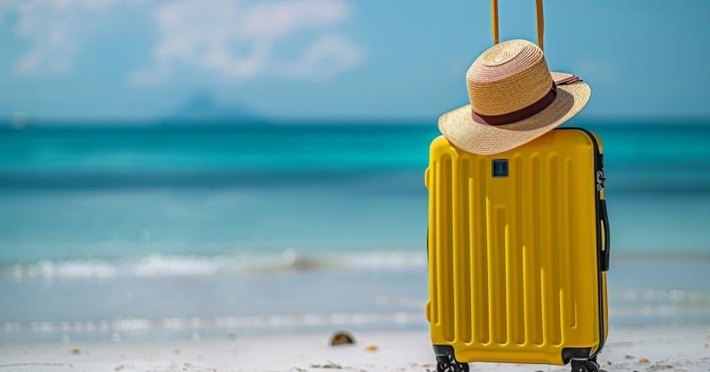 vacation beach yellow suitcase sunhat